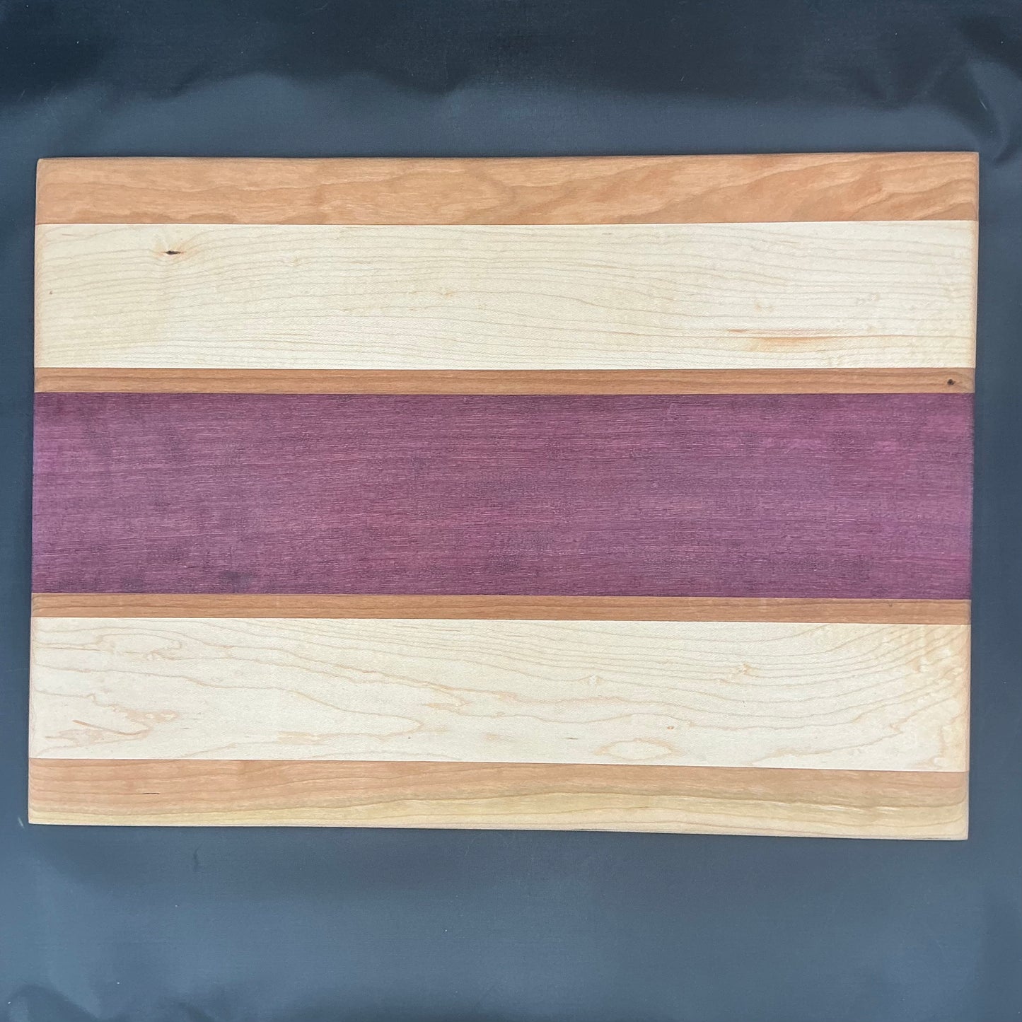 Purple Heart maple cherry. 16.5x12x.5”