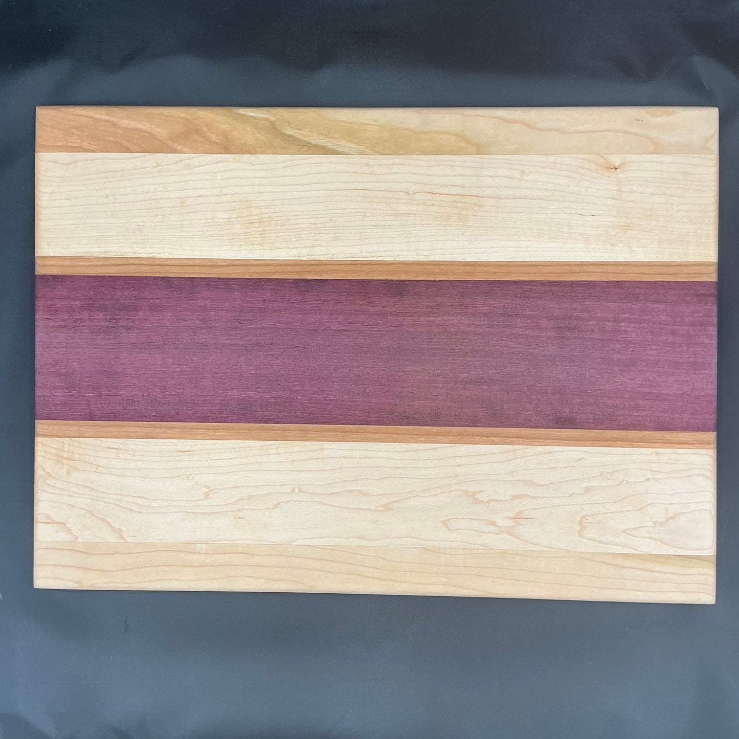 Purple Heart maple cherry. 16.5x12x.5”